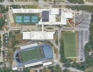 A bird's eye view of the Mt. Lebanon High School with an arrow pointing to the B-9 entrance. It is located on the Southernmost side of the building, on the left side of the theatre entrance.