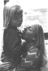 Gregory being held by his mother, Pamela Monroe.