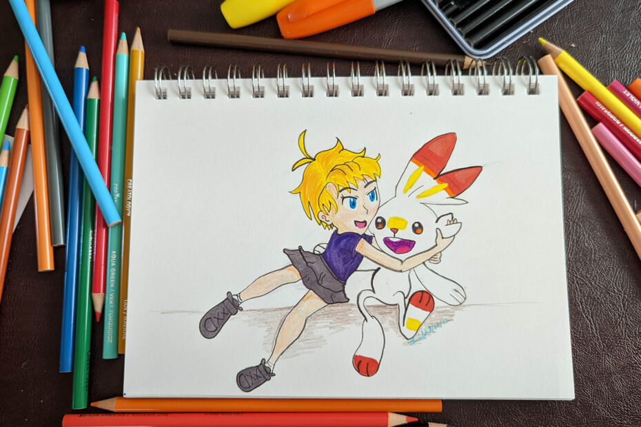 Photo of a mixed-media rendering of a young blonde kid enthusiastically hugging a Scorbunny. The artwork is done on a small notepad in pencil, colored pencil, and marker.