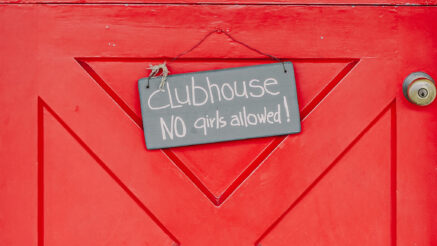 Red door with a sign nailed to it that reads: clubhouse, no girls allowed!
